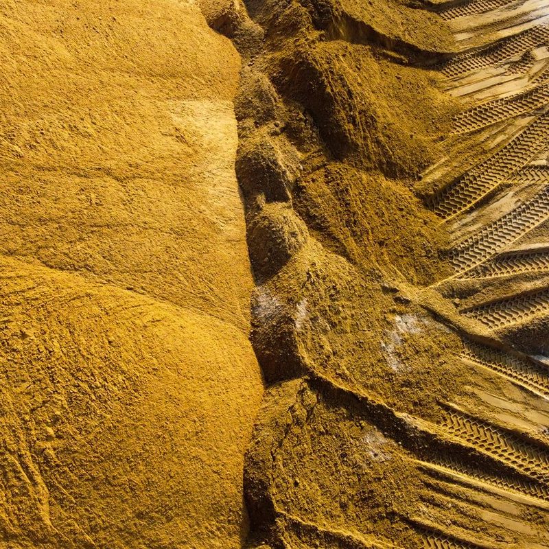 Close-up of a mound of golden construction sand